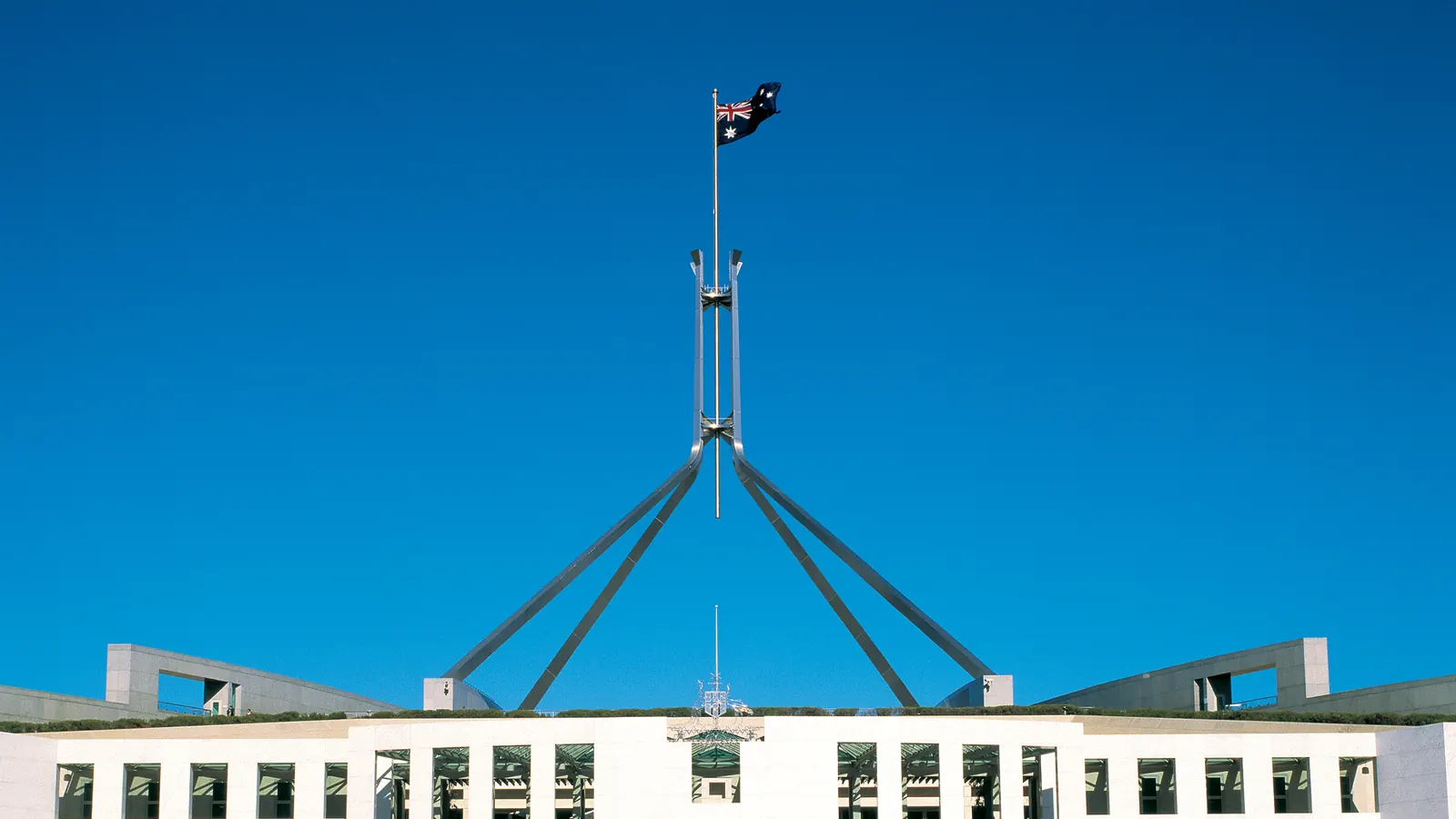 The Australian National Flag on the mast above Parliament House in Canberra