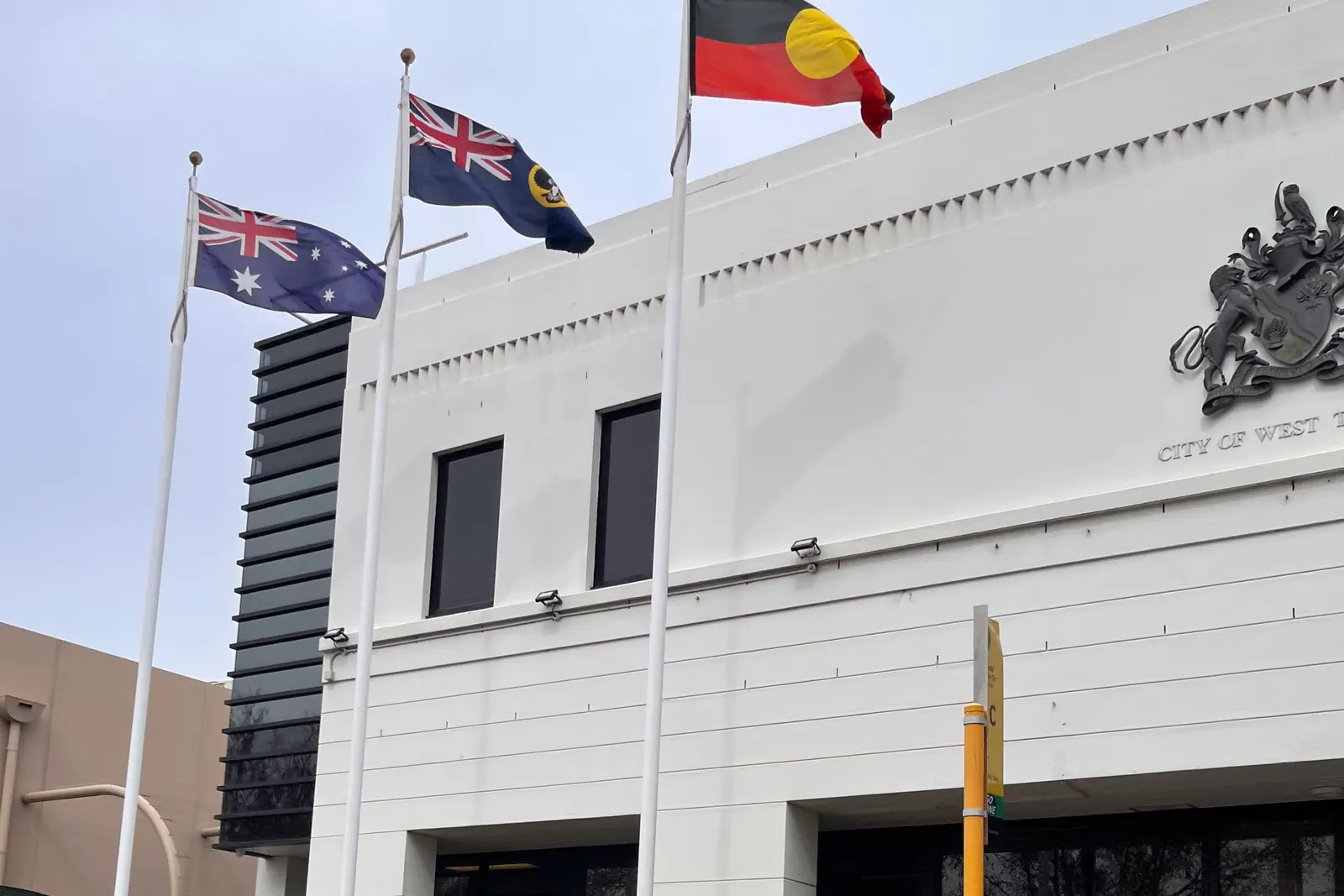 The Australian National Flag, the South Australian flag and the Australian Aboriginal Flag in front of the West Torrens council building in Adelaide