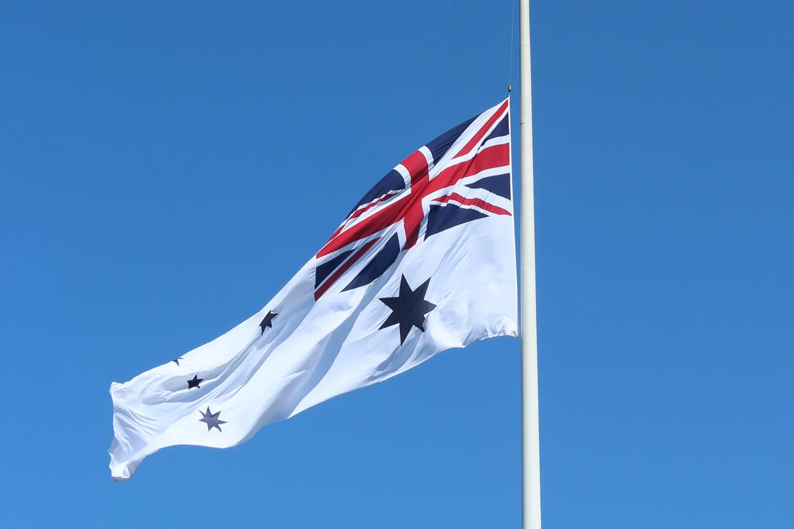 The Australian White Ensign at half-mast