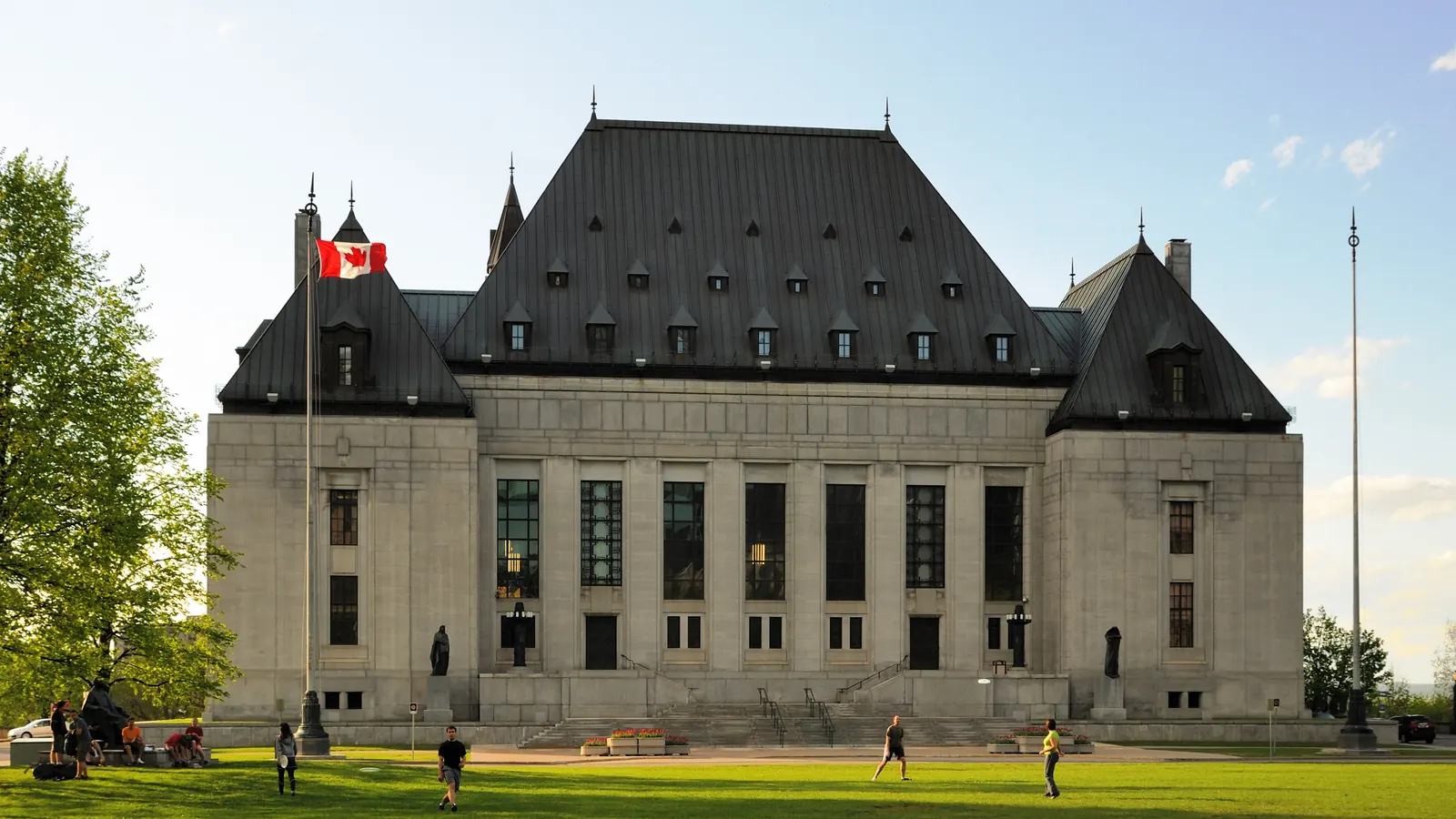 The Supreme Court of Canada building in Ottawa with the flag of Canada on the roof