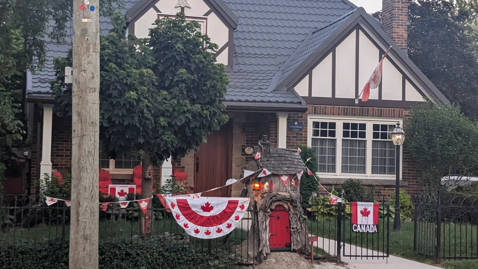 A house decorated with Canadian flags and red and white bunting for Canada Day