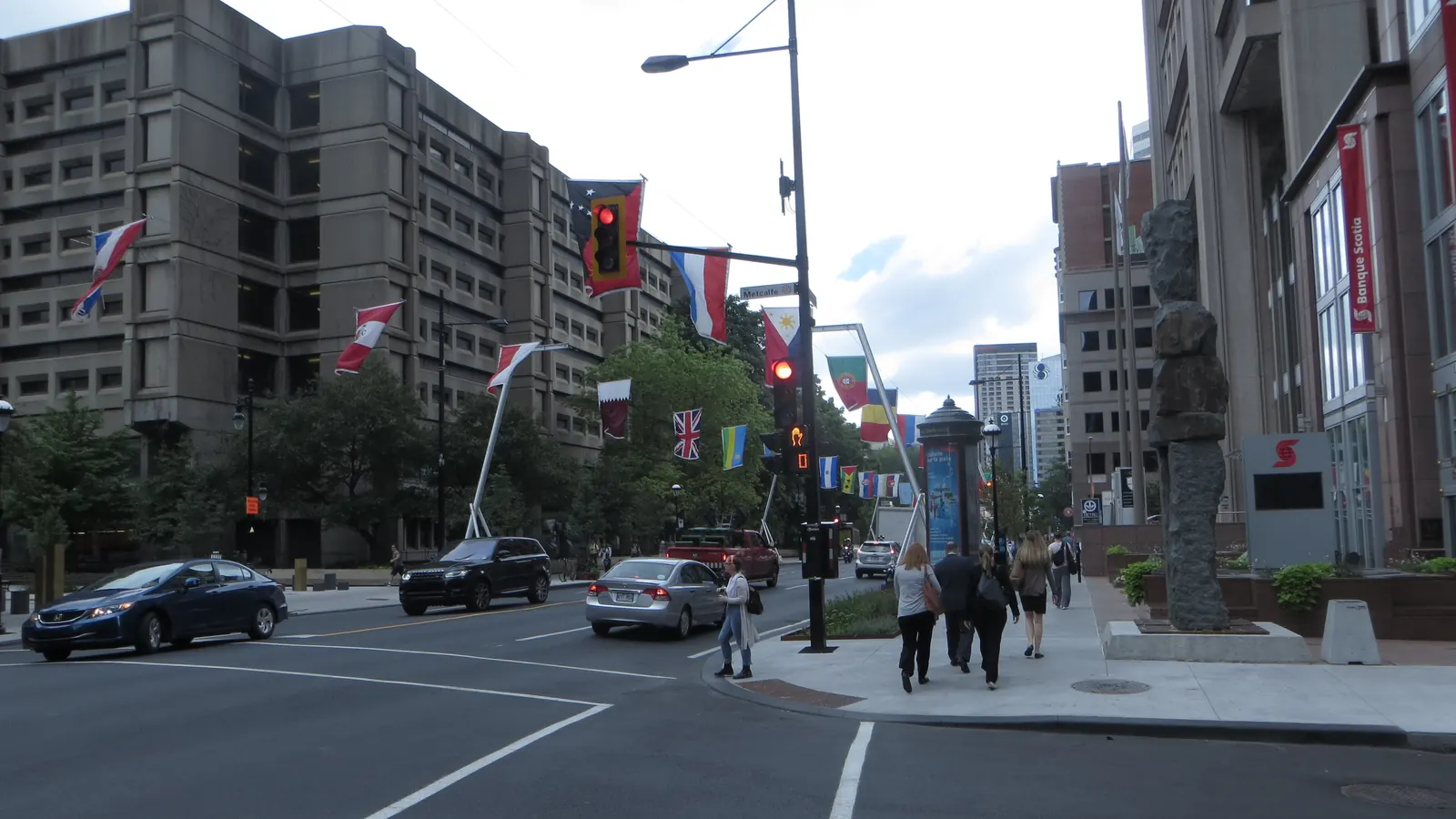 The flags of many countries on poles along a street in Montréal
