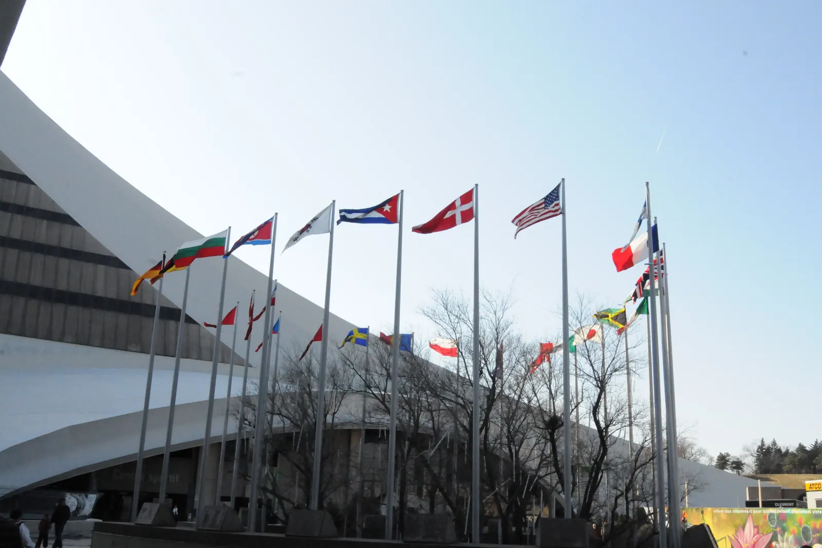 A row of international flags on flagpoles by the Olympic Stadium in Montréal