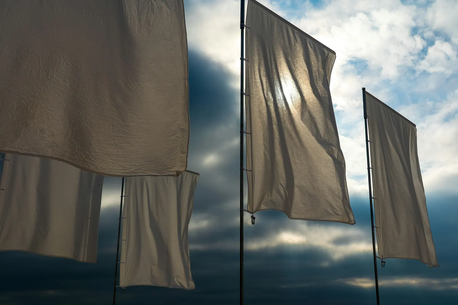 Plain flags flying in strong wind