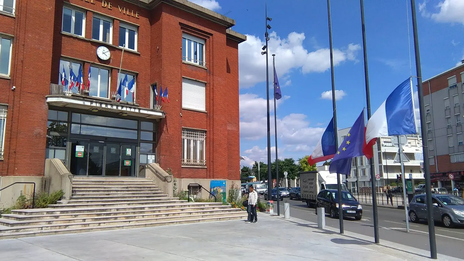 Drapeaux en berne à des mâts devant l’hôtel de ville de Pierrefitte-sur-Seine