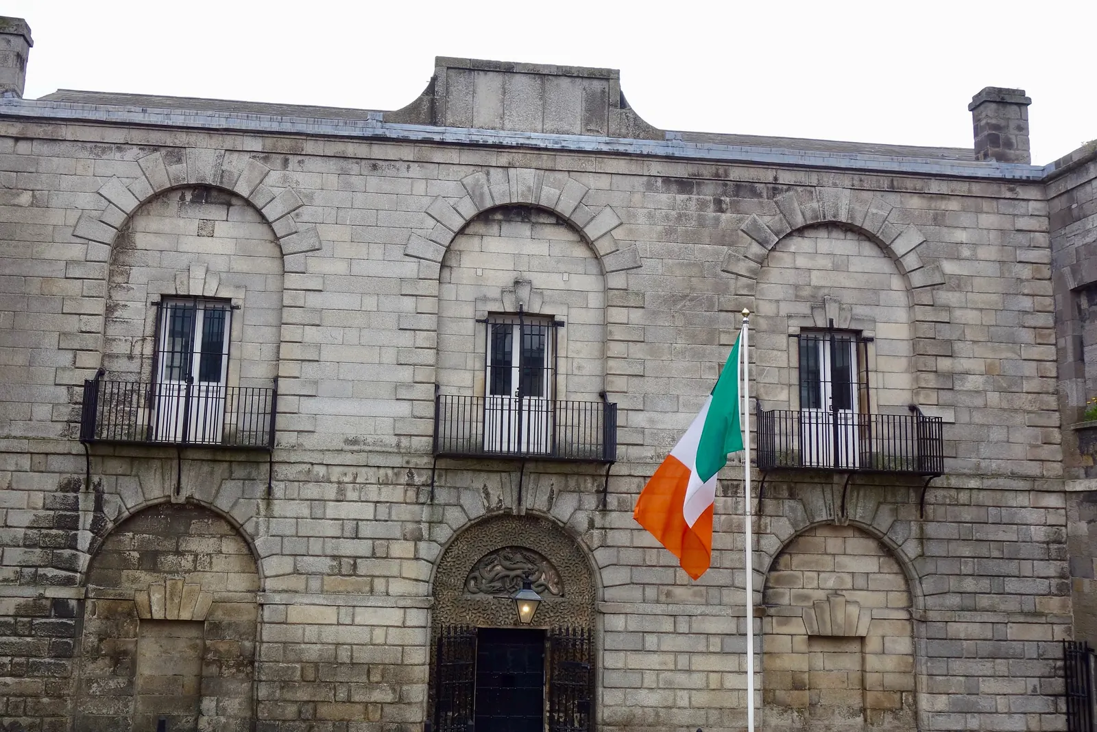 The Irish tricolour on a wall-mounted pole at Kilmainham Gaol
