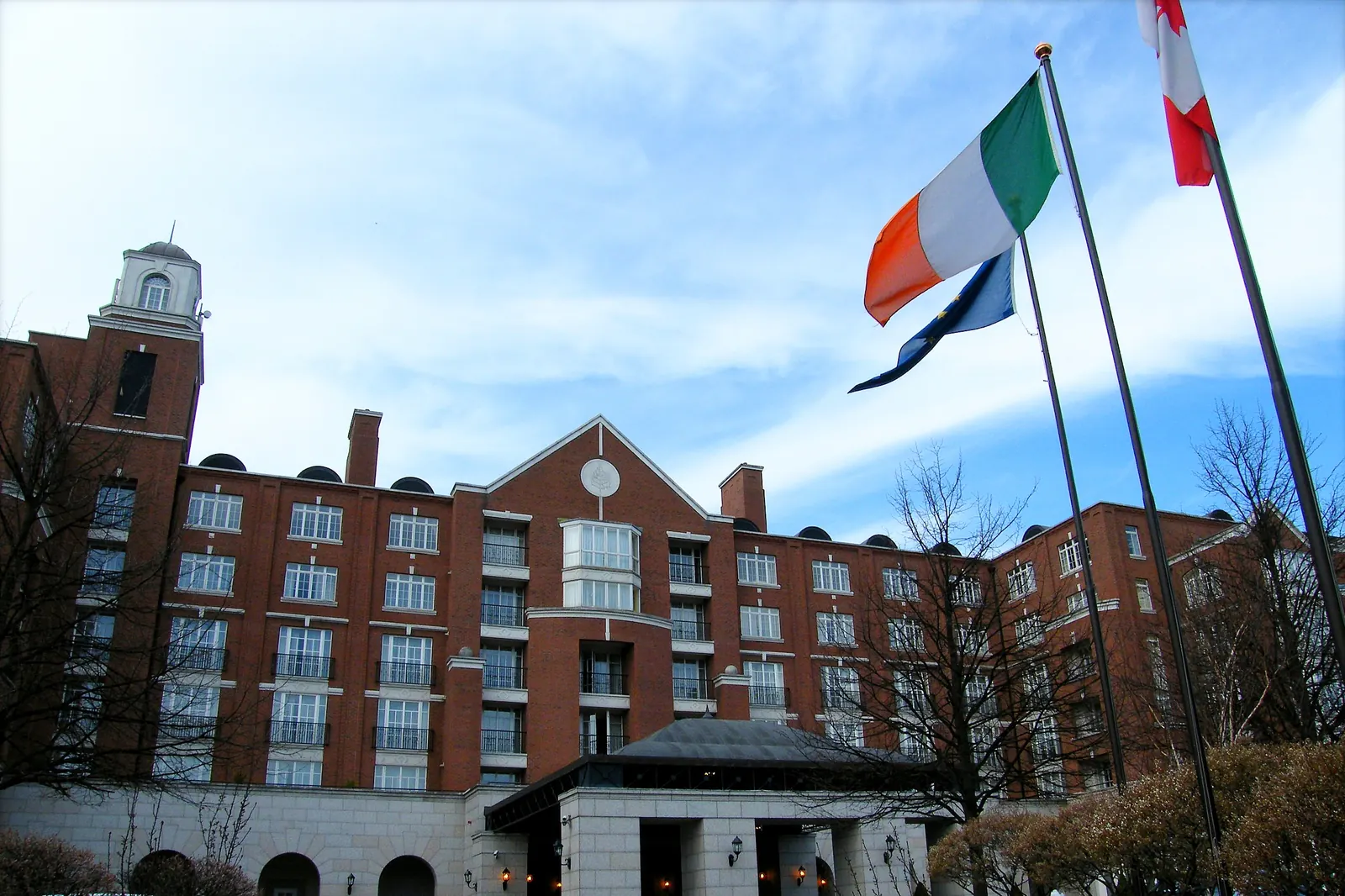 A hotel in Dublin with flagpoles along the drive