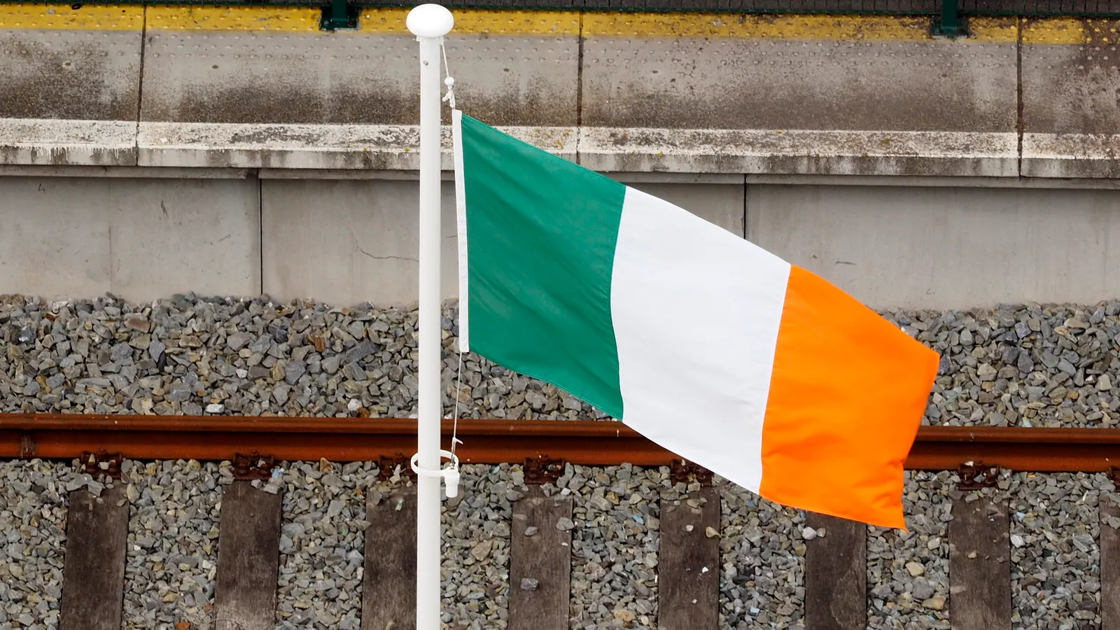 The Irish tricolour on a flagpole at the quayside in Cobh
