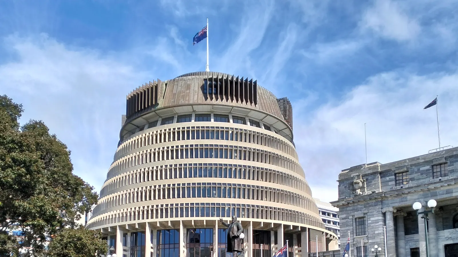 The Beehive in Wellington with the New Zealand flag on the roof