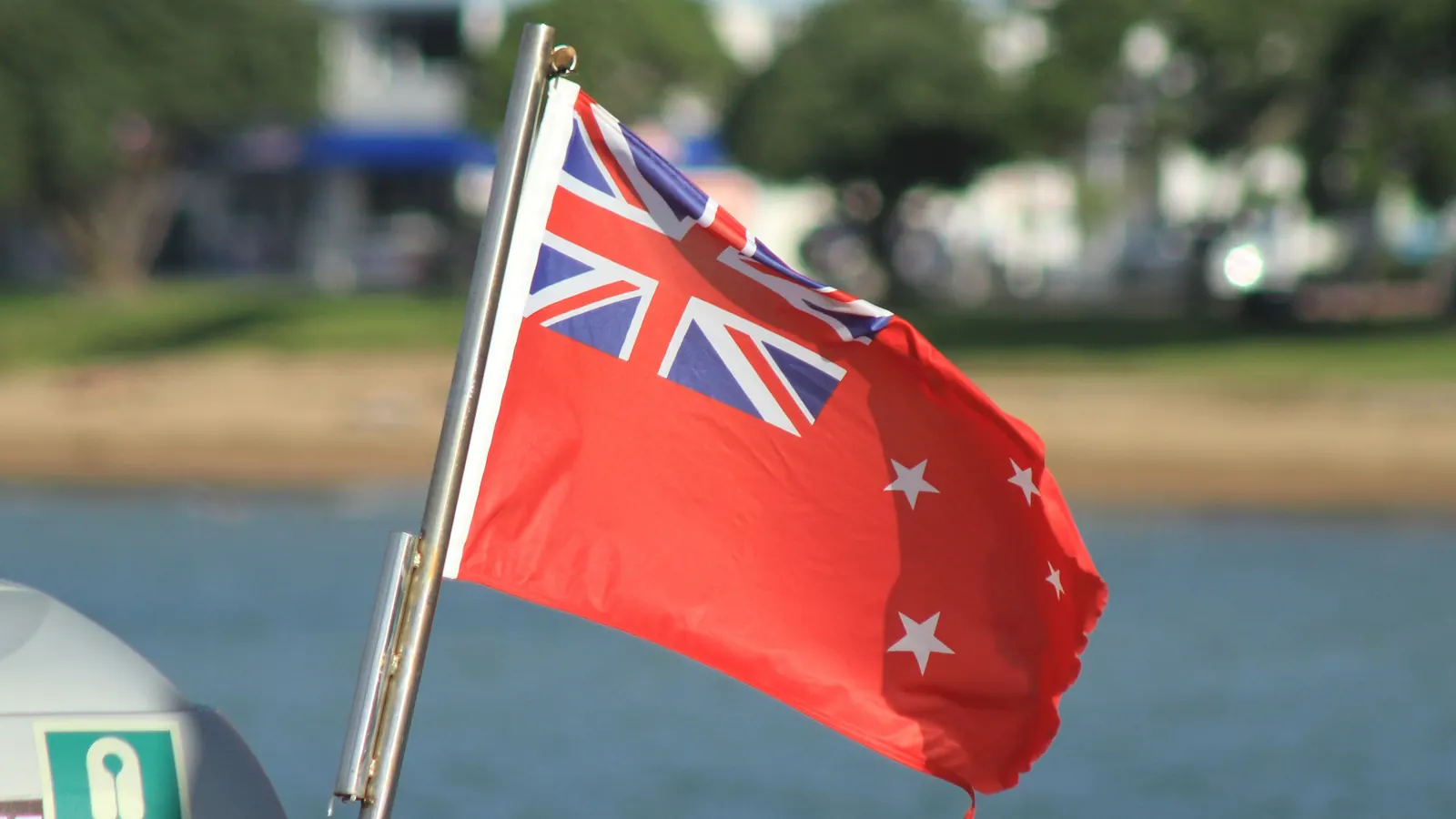 The New Zealand Red Ensign flying at the stern of a boat