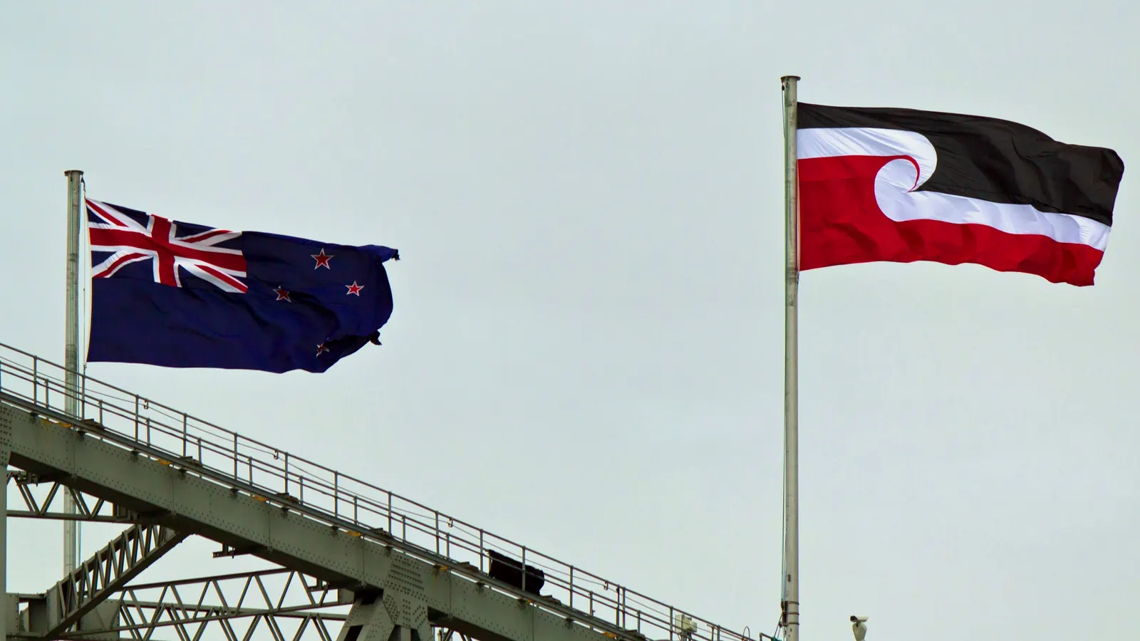 The New Zealand flag and the Tino Rangatiratanga flag on Auckland Harbour Bridge on Waitangi Day