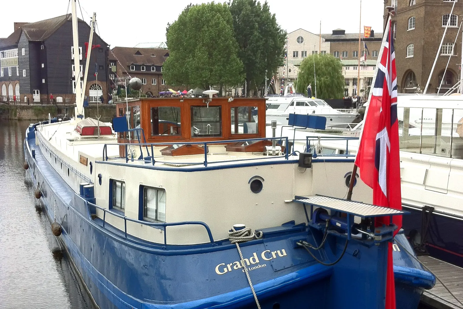 A narrowboat with the Red Ensign at the stern