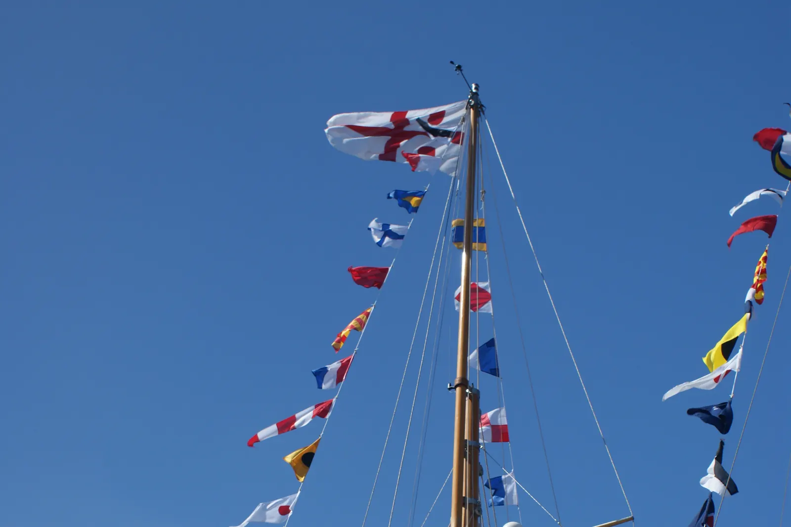 Signal flags strung on the masts of sailing boats at Yarmouth harbour