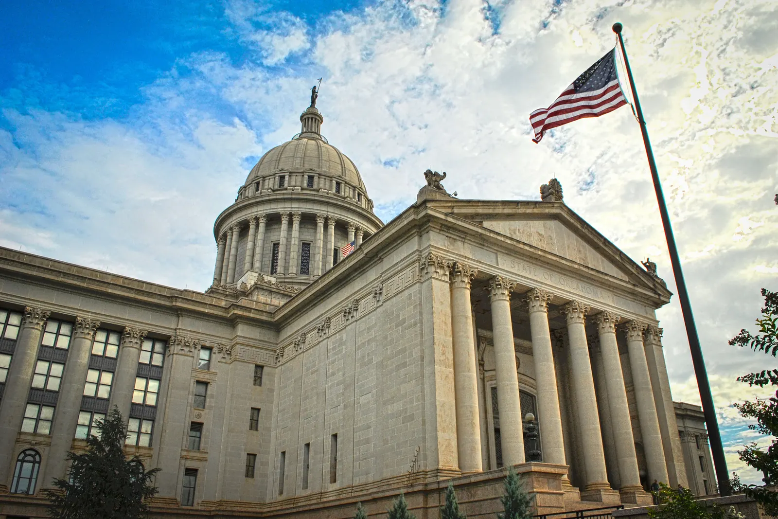 The Oklahoma State Capitol with the flag of the United States