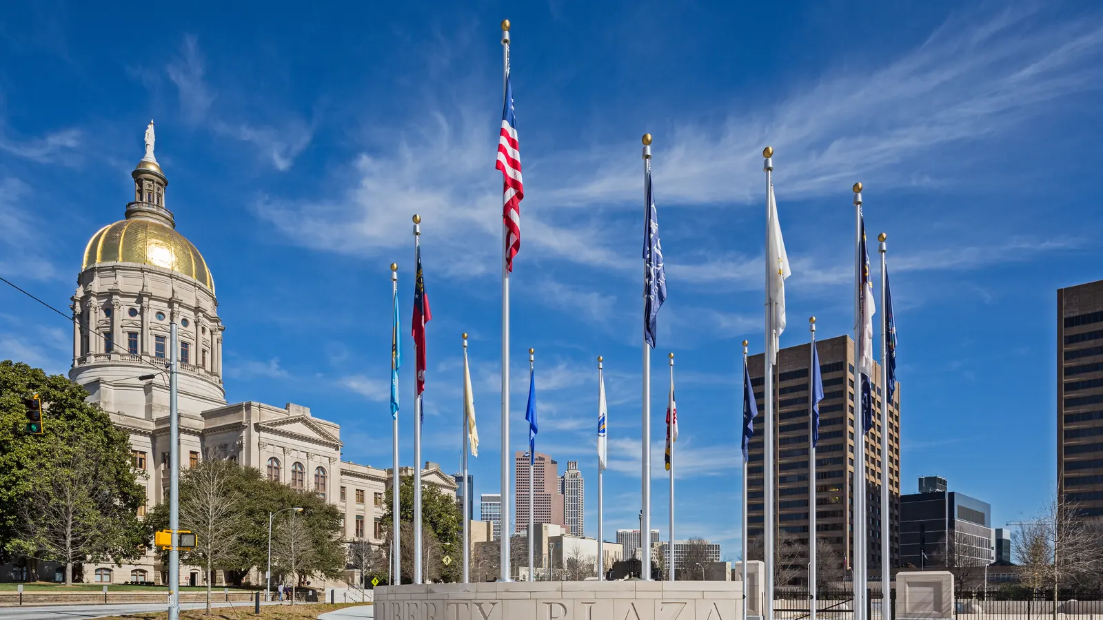 A row of flagpoles with flags at the Georgia State Capitol in Atlanta