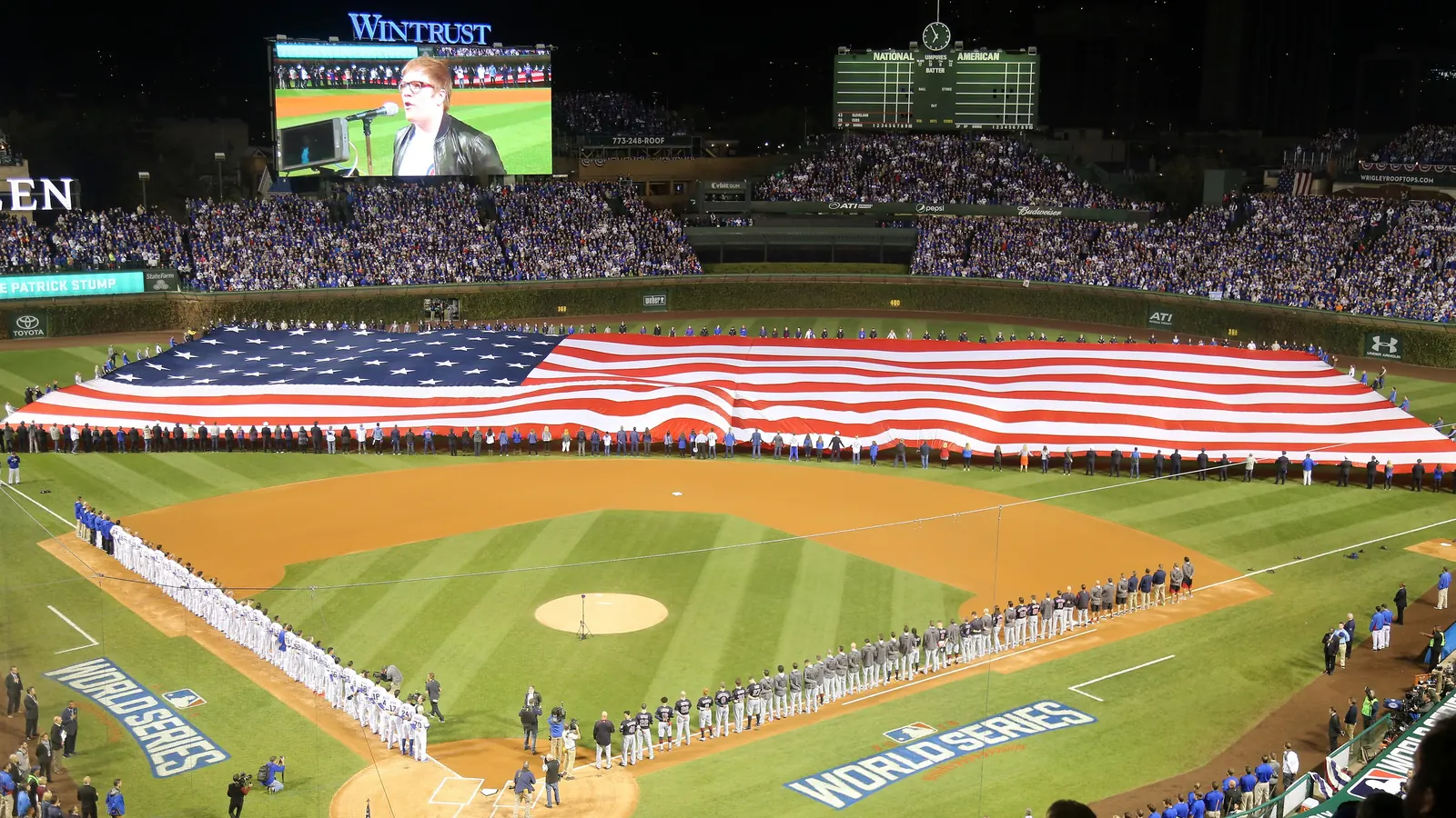 A giant flag of the United States unfurled on the field at Wrigley Field before a World Series game in 2016