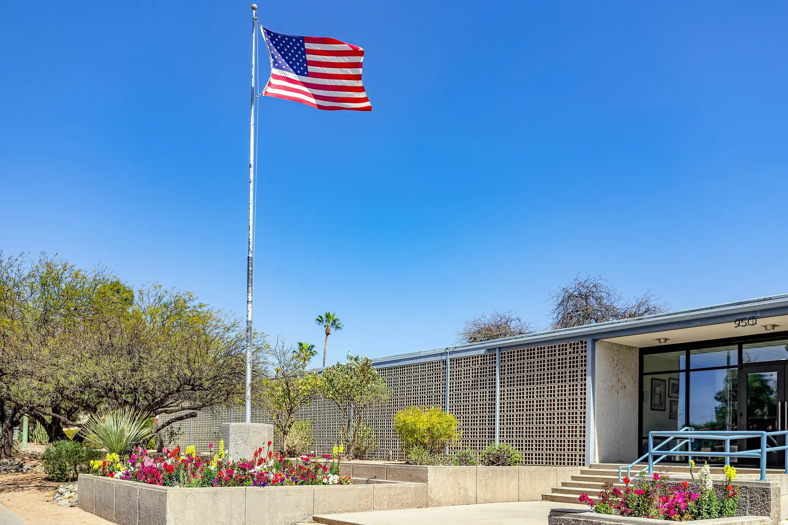 The flag of the United States on a tall flagpole in front of an office building in Tucson, Arizona