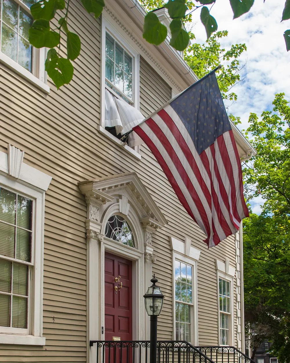 The flag of the United States in a bracket on a wooden house in Providence, Rhode Island