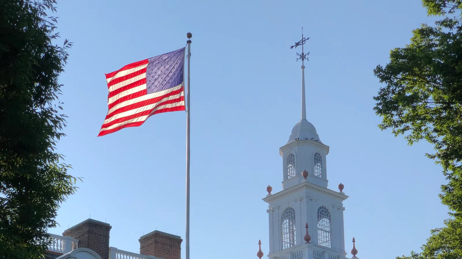The flag of the United States on a tall flagpole beside Legislative Hall in Dover, Delaware