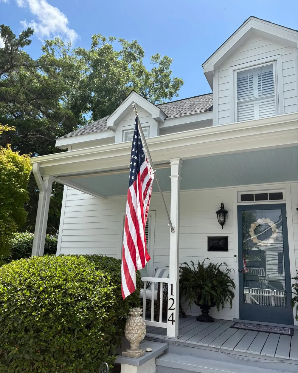 The flag of the United States in a bracket by the porch of a house in Beaufort, North Carolina