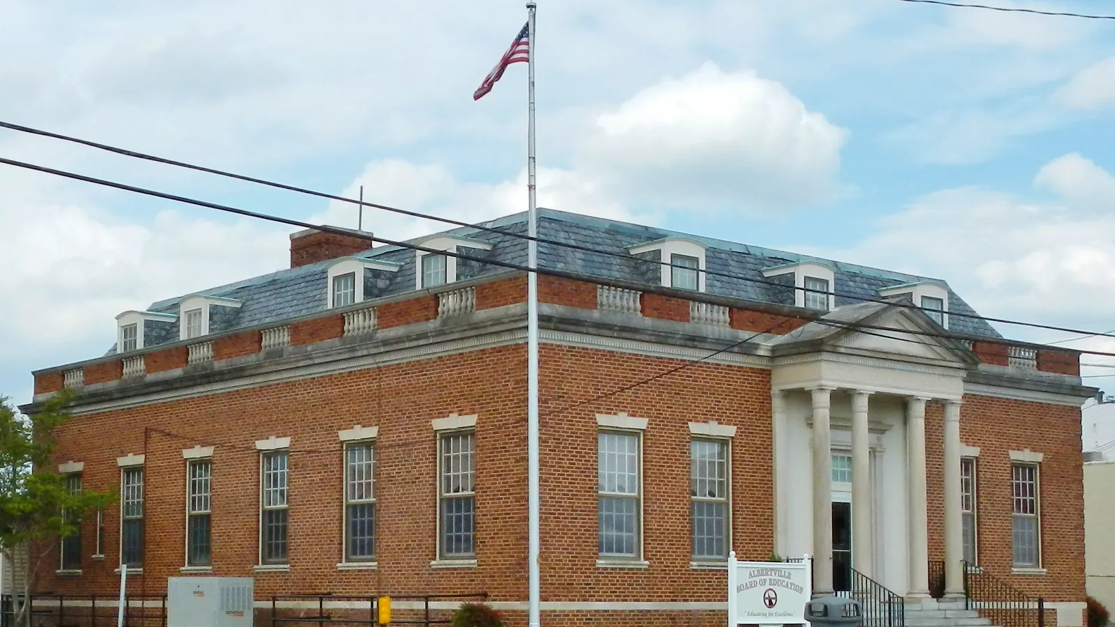 The post office in Albertville, Alabama, with the flag of the United States on a tall flagpole